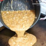 Almond roca being poured in pan to harden.