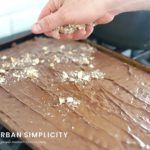 Almond being added to chocolate covered candy.