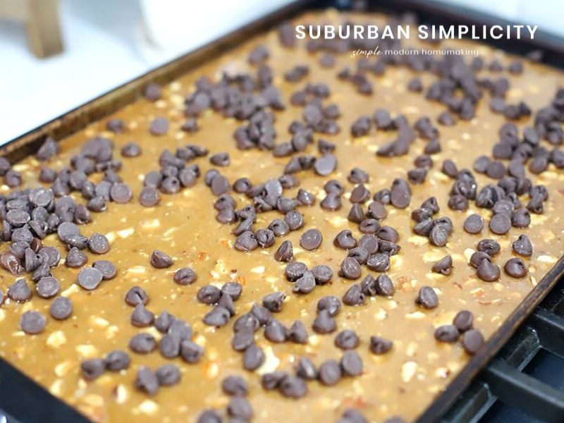 Chocolate chips being spread on caramel candy