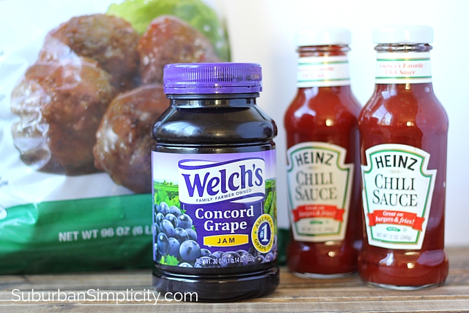 The ingredients for crockpot meatballs on a counter top - Meatballs, grape jelly and chili sauce.