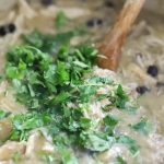 Cilantro being added to soup