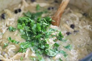 Cilantro being added to soup