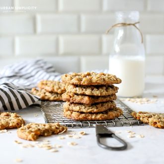 Oatmeal Scotchies stacked on a cooling rack.