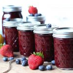 Mason jars Canned with Mixed Berry Jam. Strawberries and blueberries sound them.