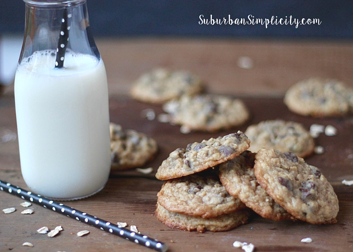 Cluster of Oatmeal cookies with a glass of milk next to them.