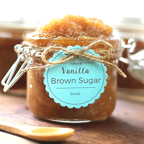 Brown Sugar DIY Scrub in a jar with a wooden spoon next to it. It has a homemade tag tied on with twine.
