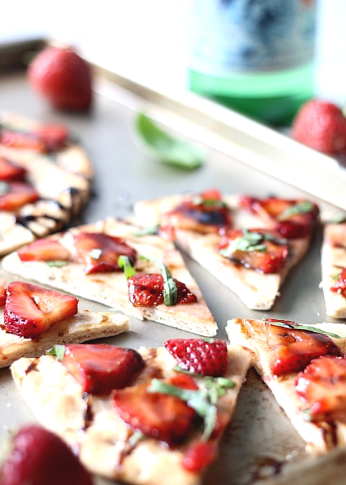 Strawberry Balsamic Flatbread cut into triangles on a baking sheet.