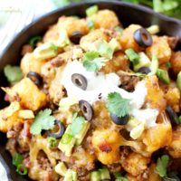 Enjoy the ultimate appetizer - Loaded Tater Tot Nachos! An irresistible recipe with crispy tots, cheese and meat will have you coming back for seconds and thirds!