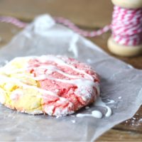 A strawberry lemonade cookie with icing on the counter