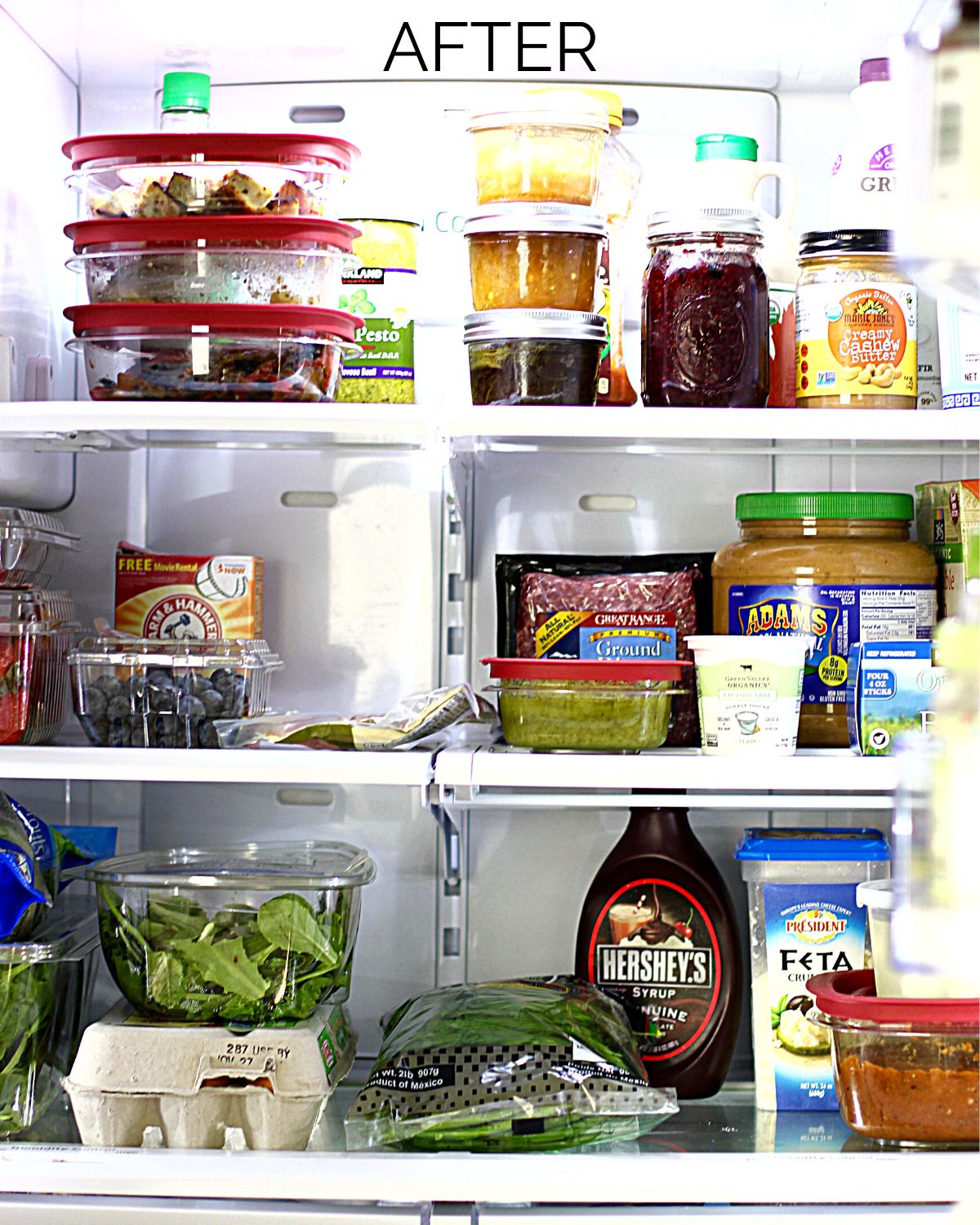 The inside of a freshly cleaned refrigerator with the food put back in.
