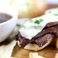 Crockpot French Dip sandwich next to a delicious dipping sauce.