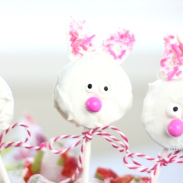 An adorable Easter bunny Oreo cookie pop with a ribbon around the stick.