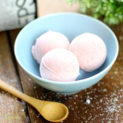 DIY Bath Bombs in a blue bowl with a spoon next to it.