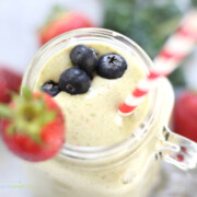 Strawberry Kale Smoothie in a mason jar with straw and strawberry garnish