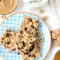 Honey Nut Cheerios protein bites on a plate with peanut butter in the background