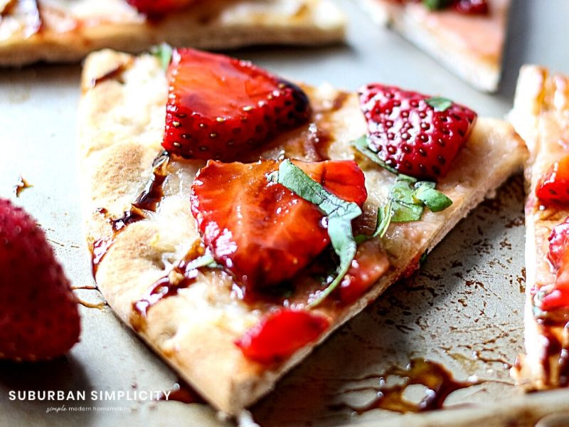 Strawberry Balsamic Flatbread is an easy recipe with lots of sweet and savory flavors. Fresh strawberries and basil on top crispy baked flatbread. The perfect summer appetizer, snack or meal!