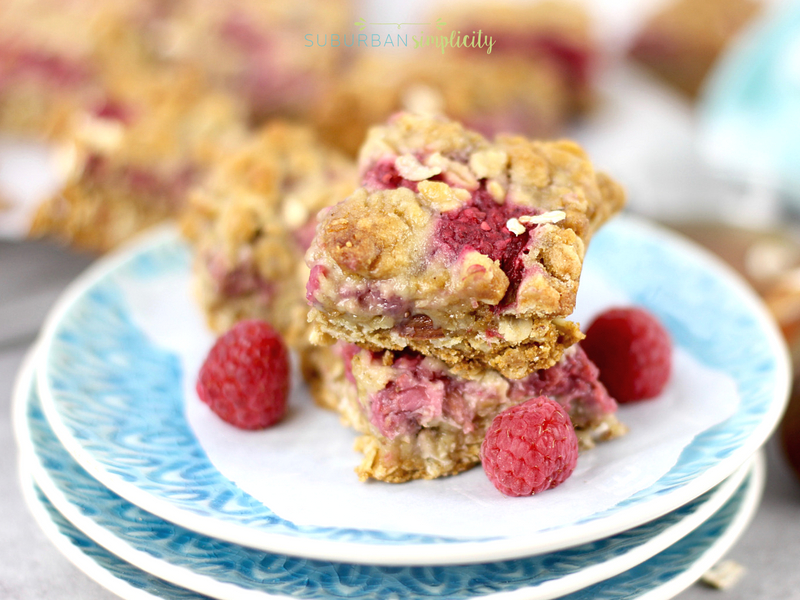 Stacked plates with raspberry oatmeal bars on top