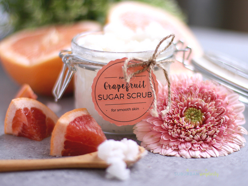 A freshly made jar of grapefruit sugar scrub with fresh grapefruit next to it.