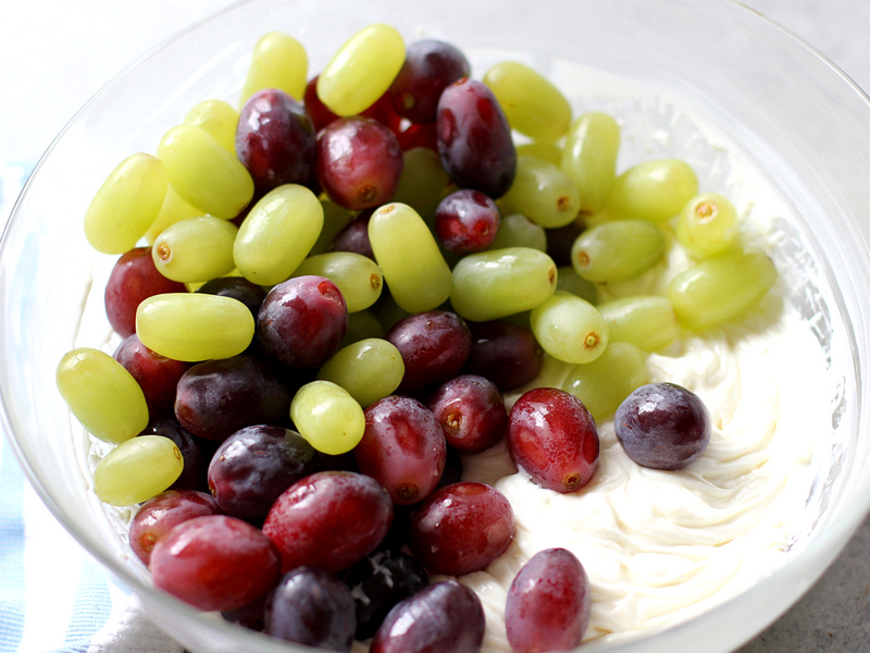 Grapes and creamy topping in a bowl.