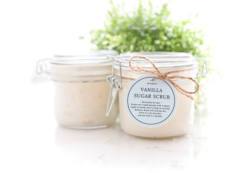 Sugar scrub on a counter with a ribbon and tag tied around it.