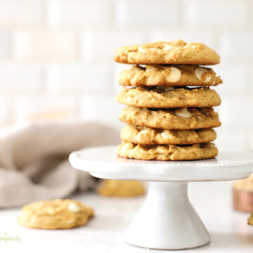Pumpkin spice cookies stacked on a cake stand.