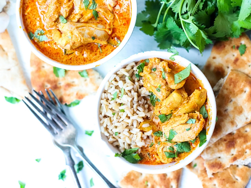 Instant Pot Butter Chicken in bowls with rice.