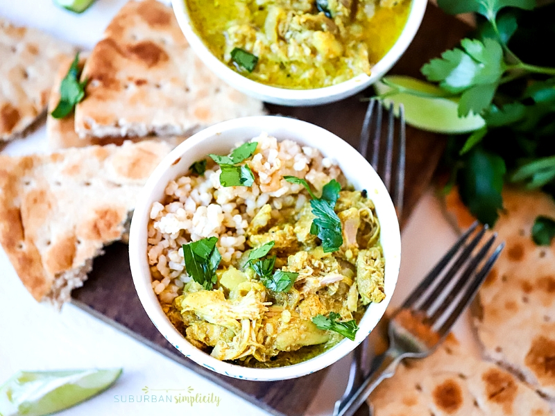 Crock Pot Chicken Curry in a bowl with parsley on top.