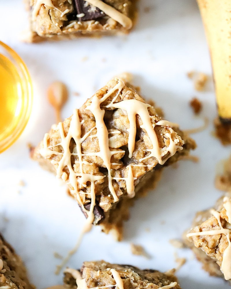 Oatmeal Banana Bars drizzled with white chocolate and peanut butter.