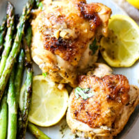 Instant Pot Lemon Chicken on a plate with roasted asparagus.