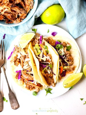 These Easy Crock Pot Pulled Pork Tacos are tender and full of slow-cooked flavor.  Plus, this simple, budget-friendly recipe is great for multiple meals.  