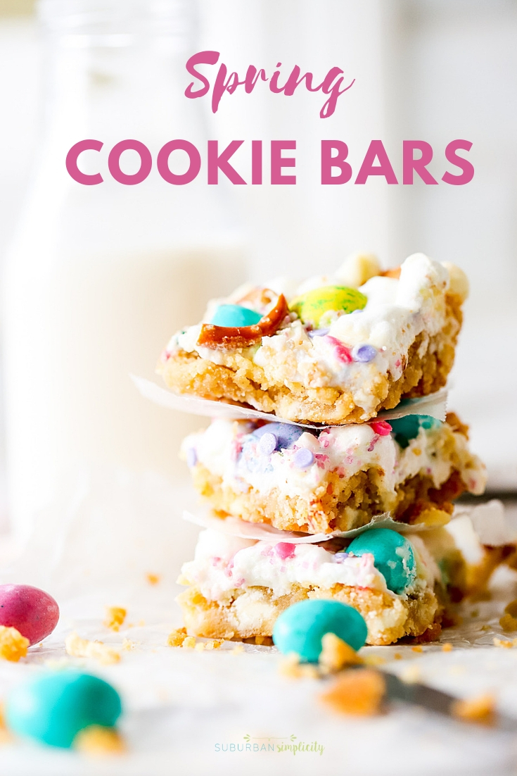 Spring Confetti Cookies Bars are the perfect Easter dessert recipe! Sugar cookie dough topped with fluffy marshmallows, spring candy and salty pretzels.