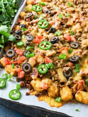 Sheet pan with loaded tater tot nachos.