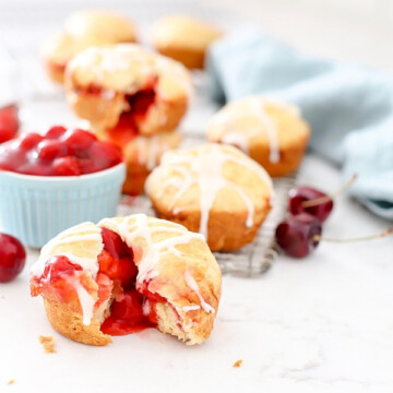 Cherry Pie Bombs on a counter with fresh cherries.