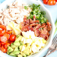 Ingredients for a Cobb Pasta Salad in a bowl.