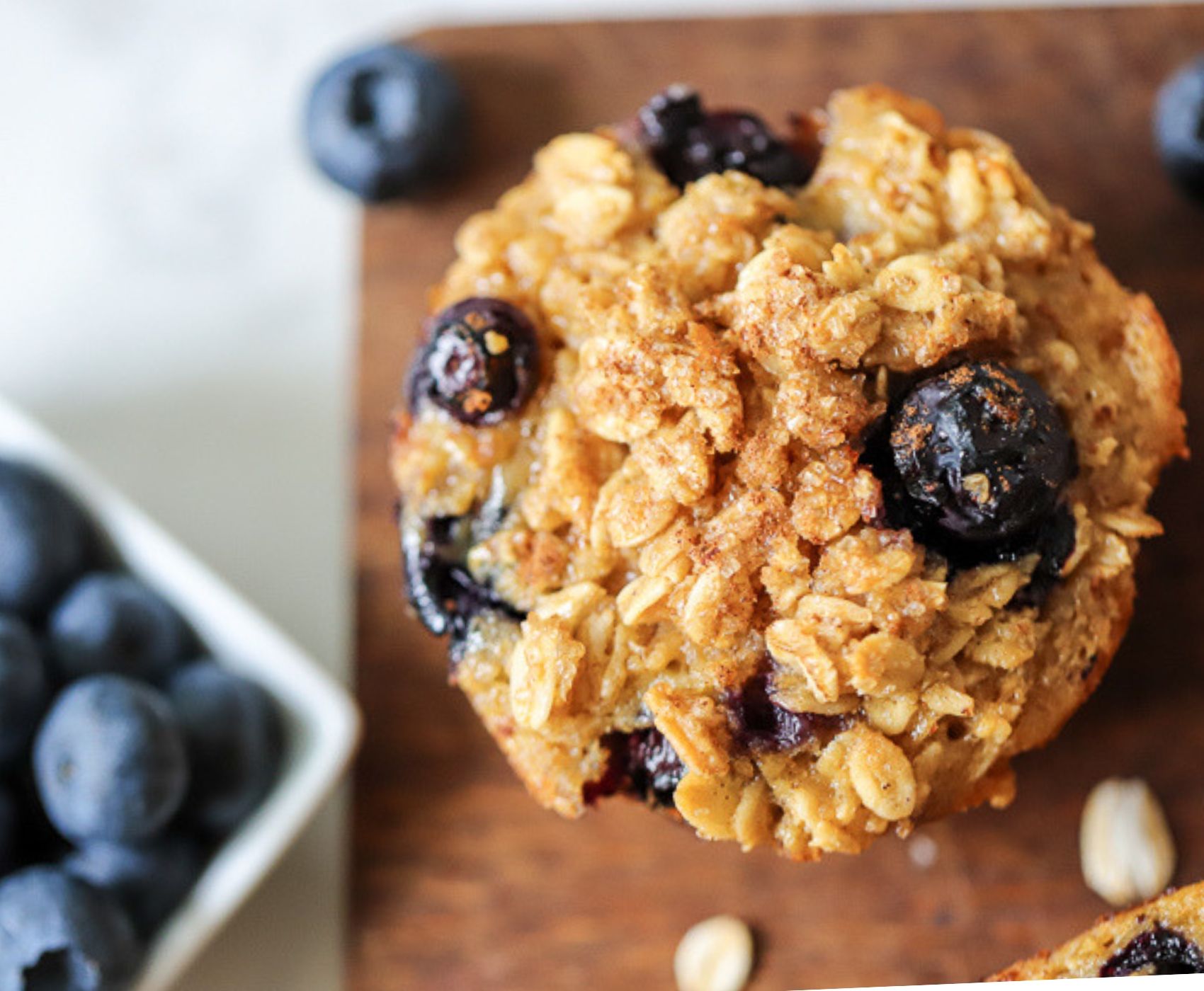 Baked oatmeal cups with blueberries next to it