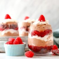 Raspberry Chocolate Mousse Trifle in a cup with raspberries next to it