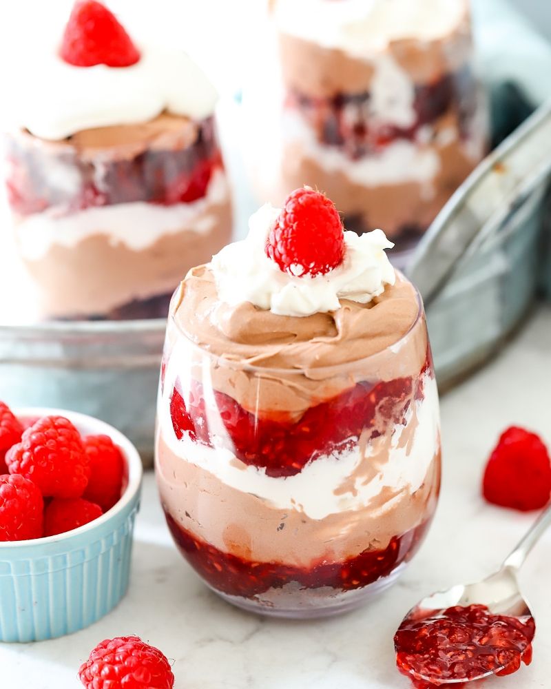 Raspberry chocolate mousse trifle next to a bowl of raspberries