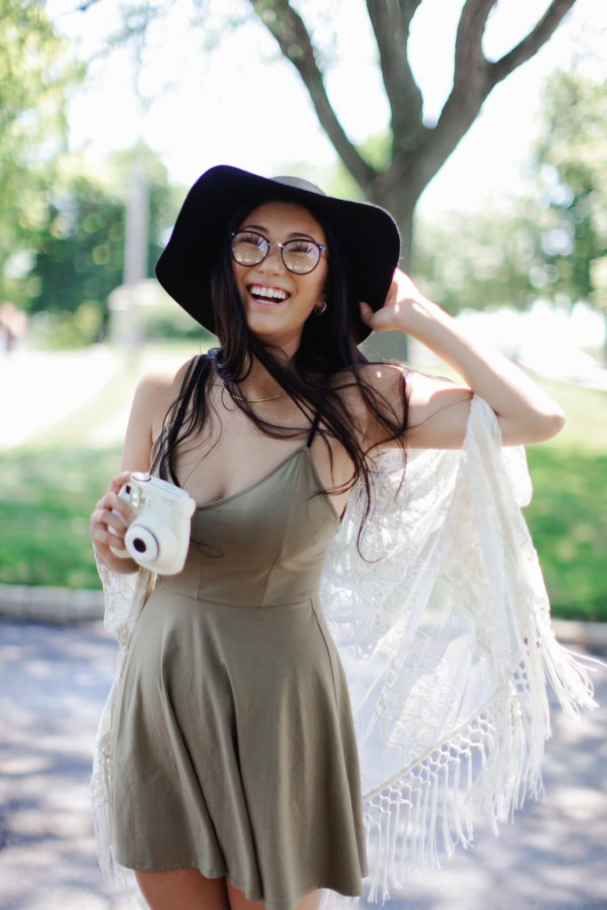 A woman wearing a dress with a camera