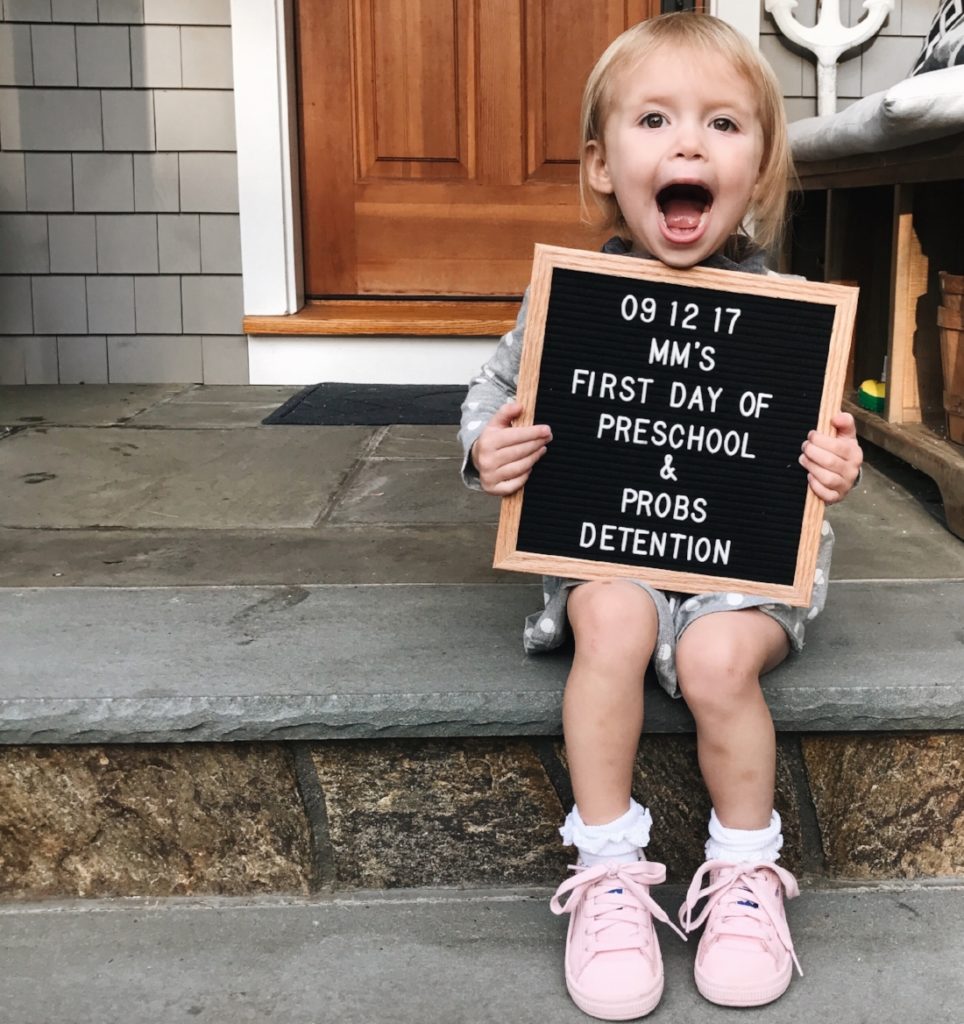 A young child holding a sign
