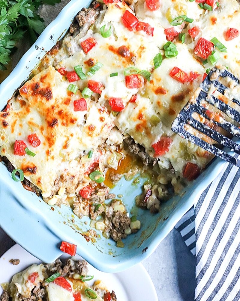 Beef enchilada casserole with a piece cut out.