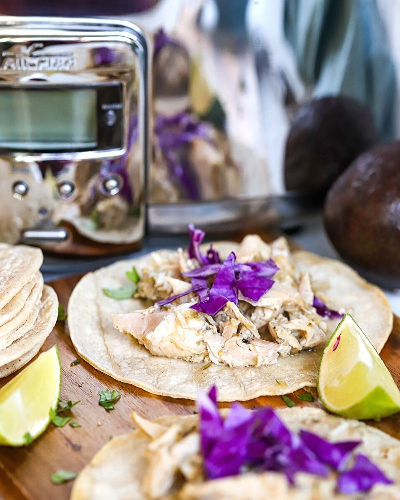 Salsa Verde Chicken next to a crock pot