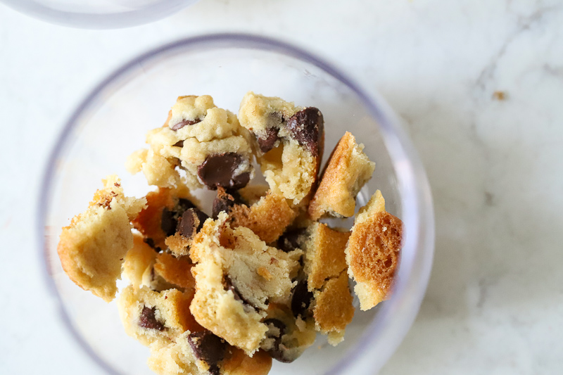 Chocolate chip cookies pieces in the bottom of a glass.