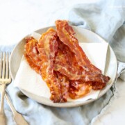 Follow these tips for How to Cook Bacon in the Oven for less mess and a deliciously easy snack or addition to any meal!