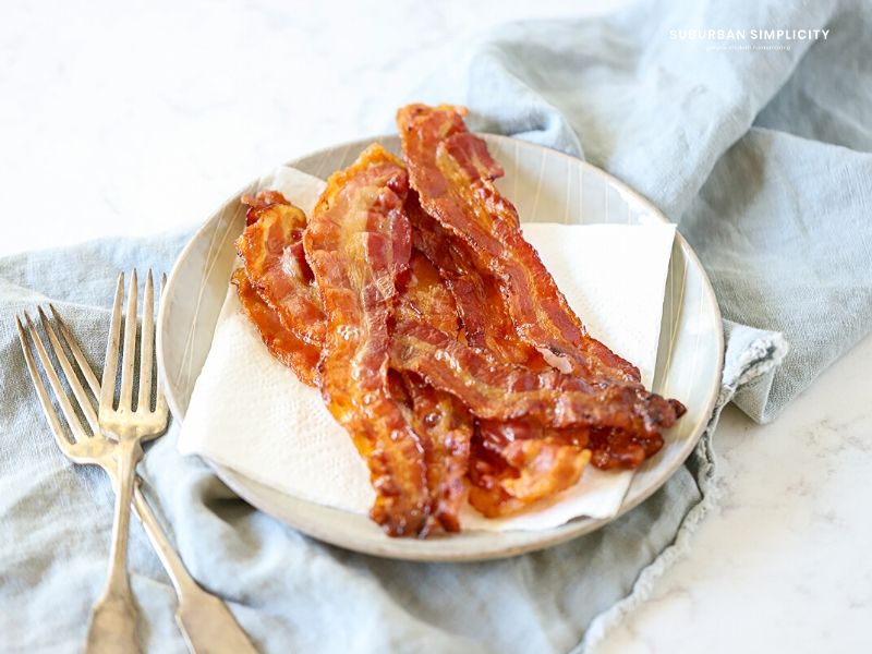 Follow these tips for How to Cook Bacon in the Oven for less mess and a deliciously easy snack or addition to any meal!