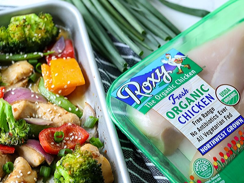 Asian sesame chicken in a pan with a package of chicken next to it