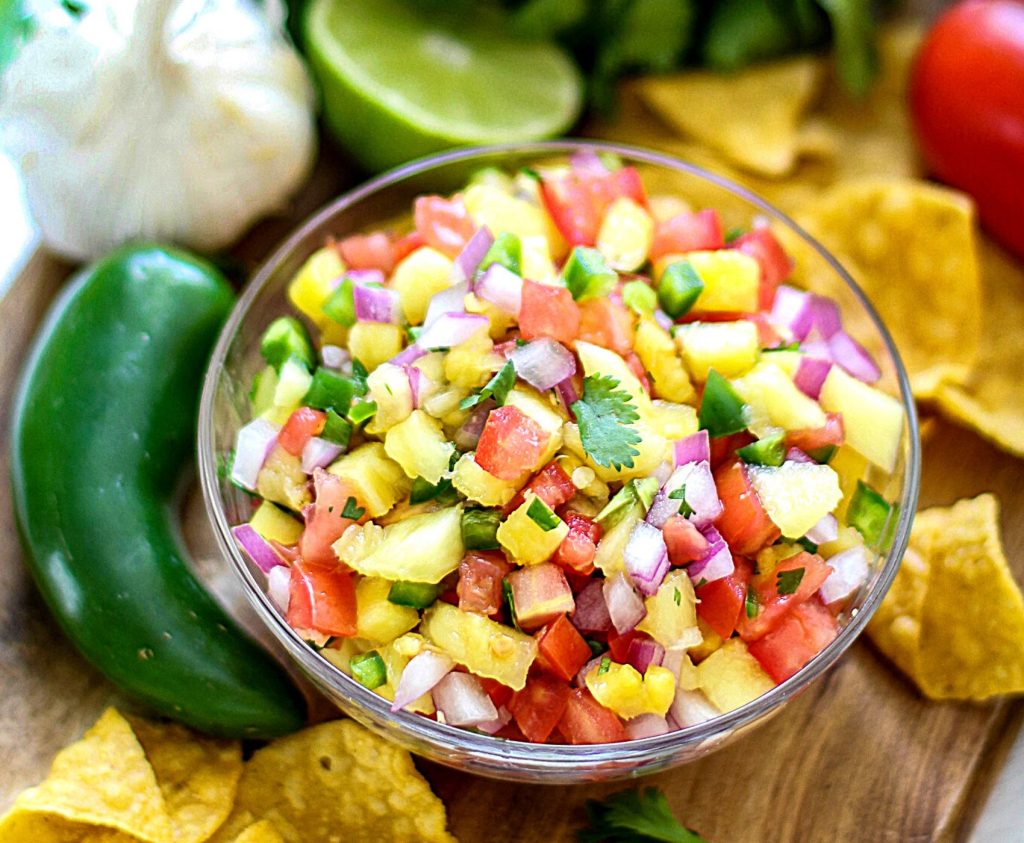 Fresh Pineapple Salsa is an incredibly easy recipe that wows both in flavor, and it's colorful presentation. With a few simple ingredients, you have a healthy snack, appetizer, or recipe topper that's not only flavorful; it's light and 100% delicious!