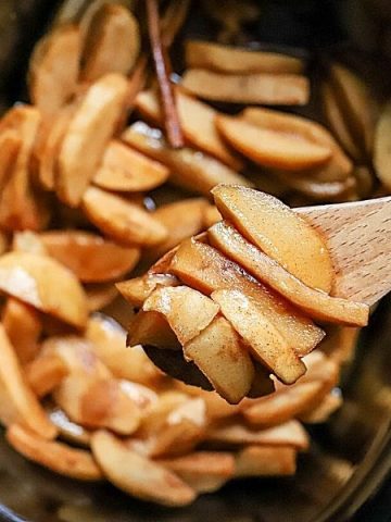 Crockpot Apples with Cinnamon takes minutes to prep and tastes fantastic. These slow-cooked, tender and flavorful apples are great for breakfast on oatmeal and pancakes or served with ice cream for dessert! Baked apples have never been so easy.