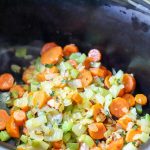 vegetables being added to crockpot