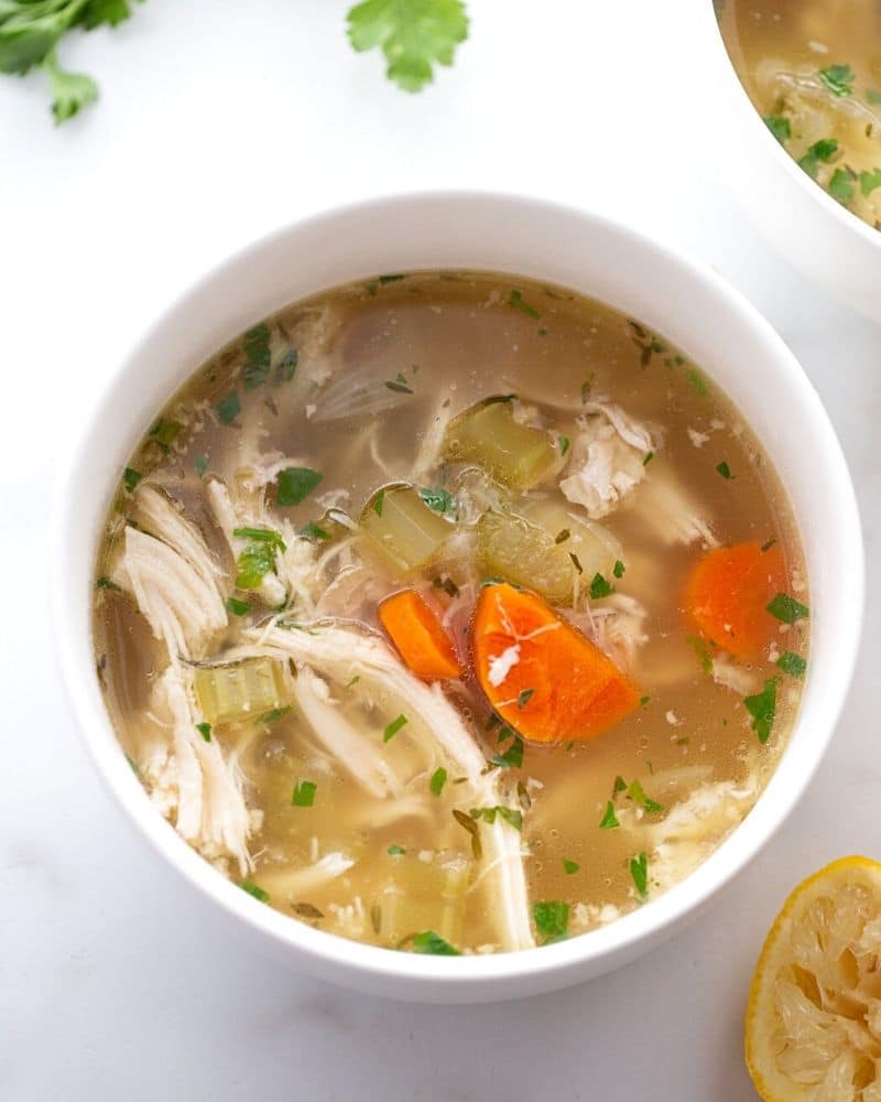 Chicken Soup in a bowl with carrots on top.