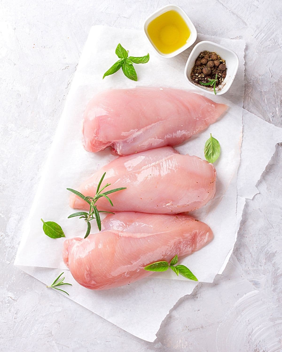 raw chicken on parchment paper.